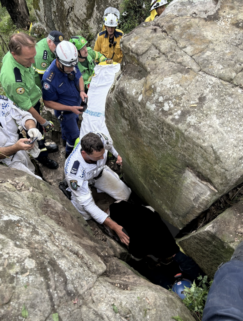 workers from NSW Ambulance removing rocks to free trapped woman
